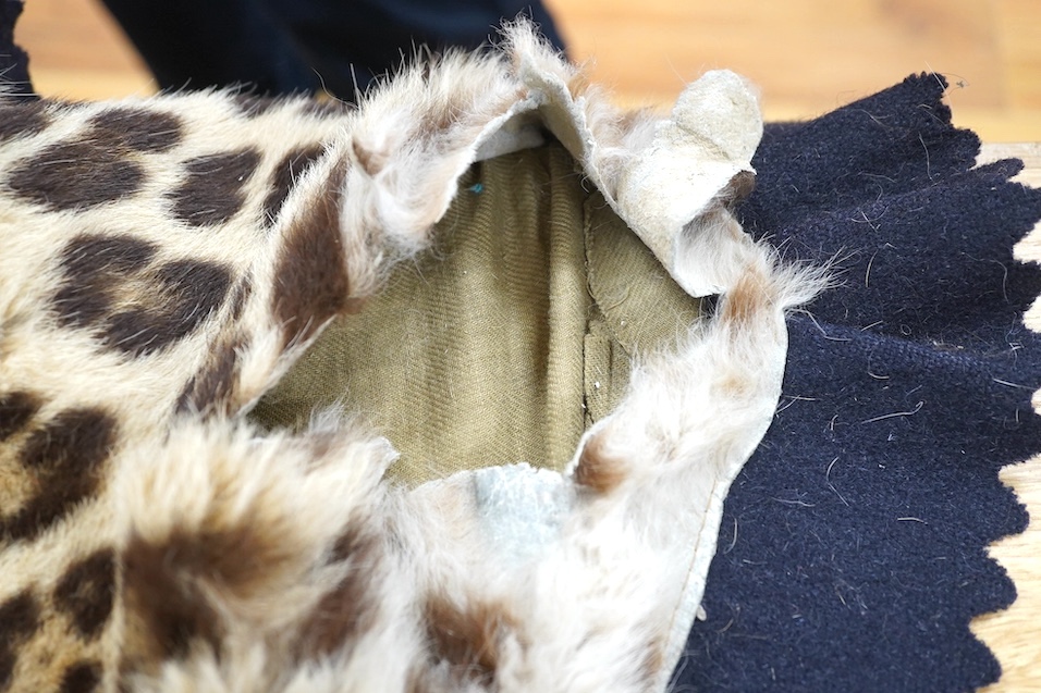 An early 20th century leopard skin rug with taxidermy head by van Ingen and van Ingen, Mysore, makers name stamped to the back, 215cm long. Condition - poor